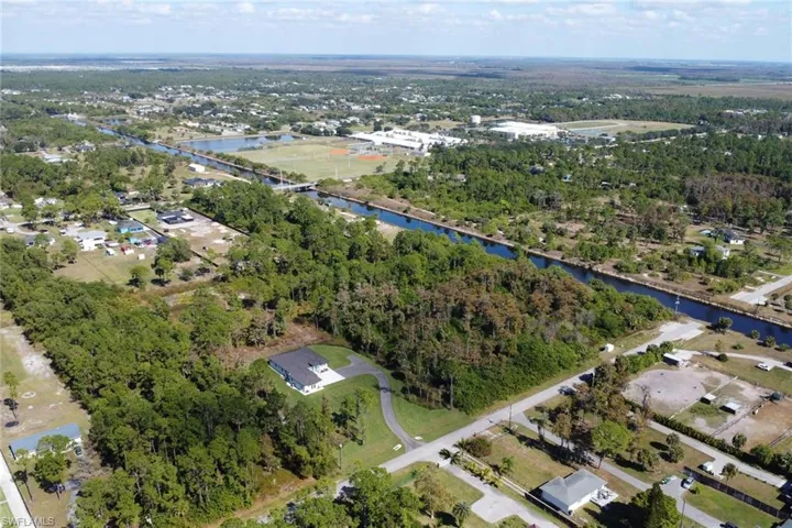Aerial view of property and surrounding area featuring a nearby body of water