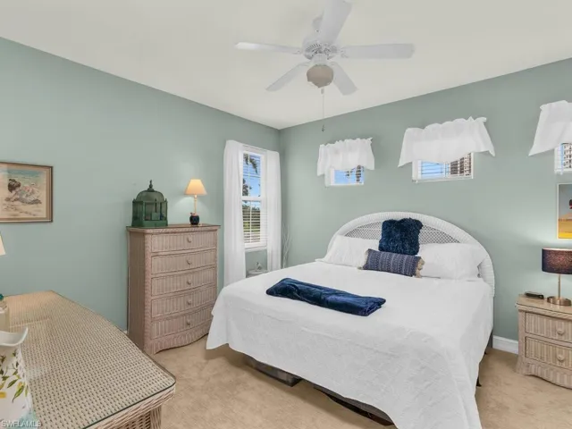 Bedroom featuring light carpet and ceiling fan