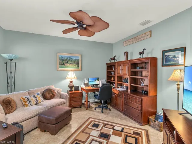 Home office featuring light tile patterned flooring and ceiling fan