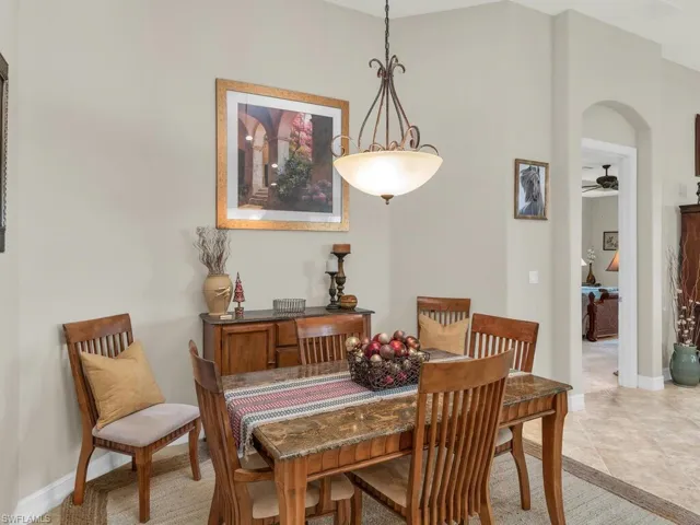 Tiled dining area featuring ceiling fan