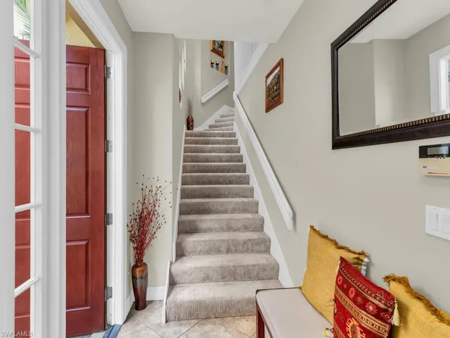 Stairs with tile patterned floors