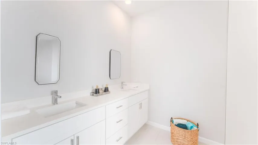 Primary Bathroom with tile patterned flooring and vanity
