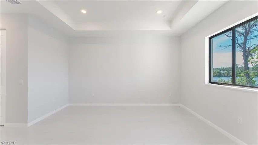 Spare room with a tray ceiling