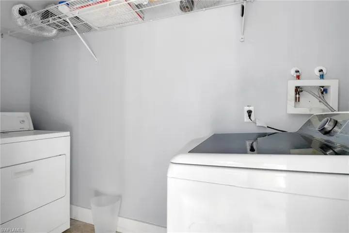 Laundry inside enclosed closet in carport