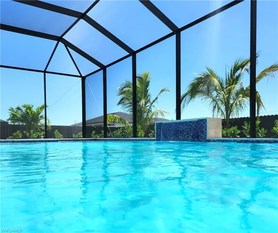 Outdoor pool with glass enclosure and a sunroom