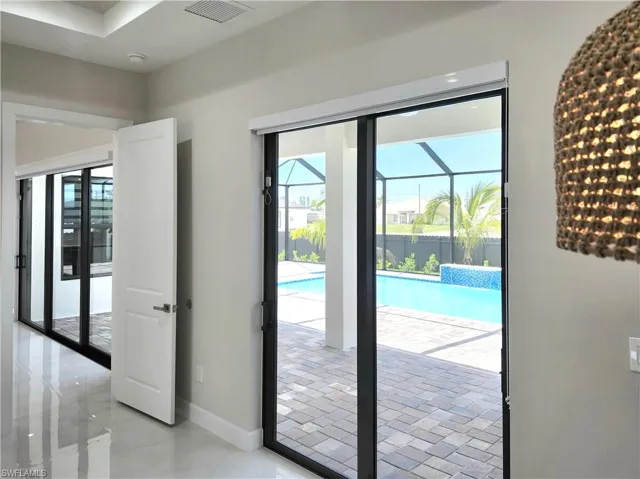 Doorway featuring plenty of natural light and a sunroom