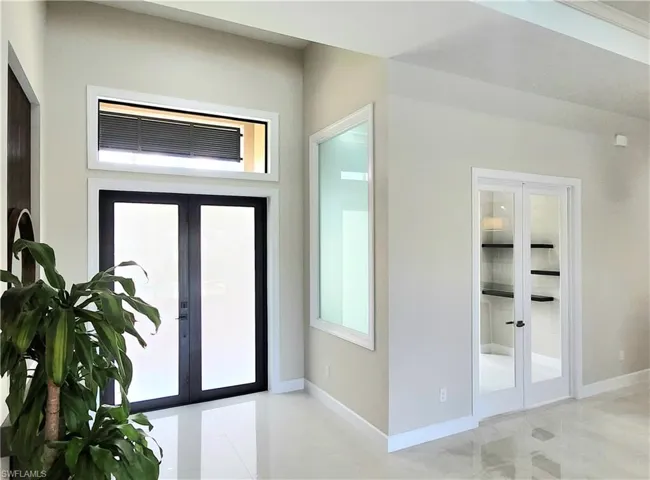 Foyer featuring french doors and plenty of natural light