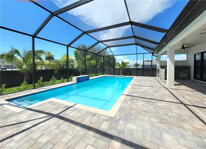 View of pool featuring a patio, a fenced backyard, a sunroom, a ceiling fan, and a lanai