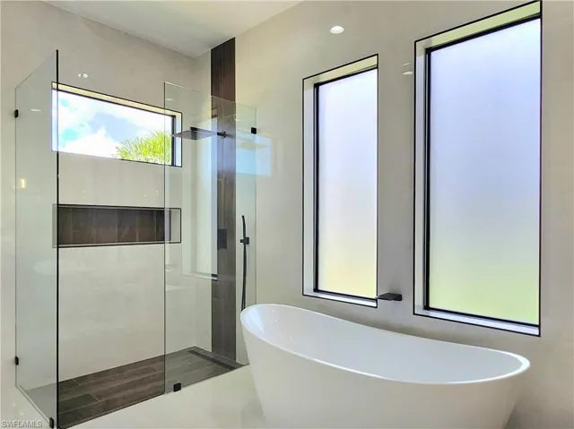 Full bathroom featuring a freestanding tub and a walk in shower