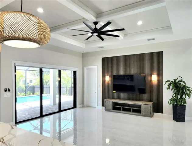 Living area featuring coffered ceiling, beam ceiling, ceiling fan, and recessed lighting