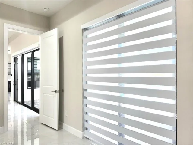 Hall featuring baseboards and radiator
