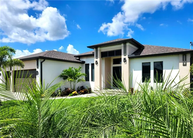 Prairie-style home with stucco siding, a shingled roof, and an attached garage