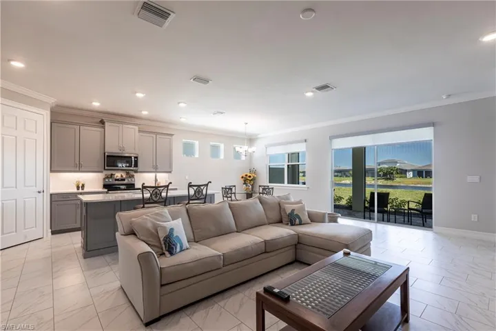 Great Room Arrangement ~Spacious and Opens to Lanai ~Custom Electric Blinds on Sliding Doors and Kitchen Window