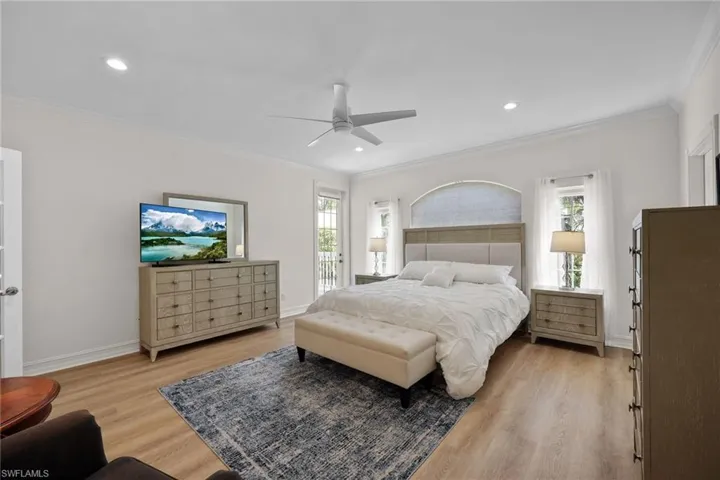 Bedroom featuring light wood finished floors, crown molding, access to outside, recessed lighting, and baseboards