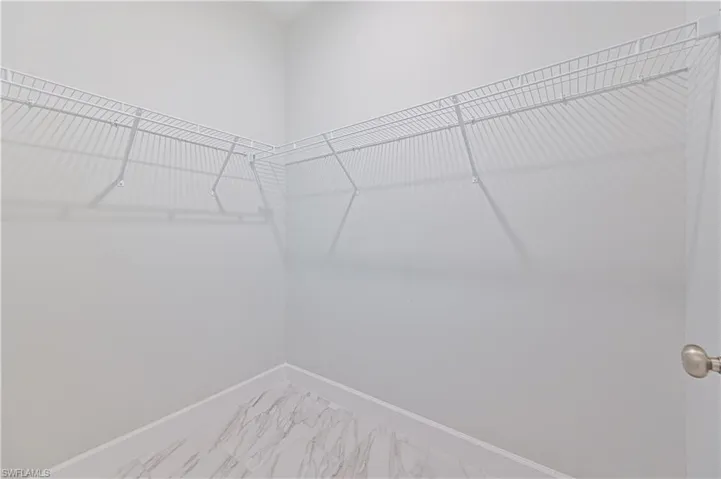 Walk in closet featuring tile floors