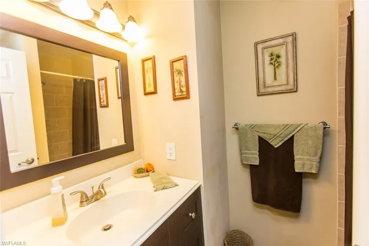 Guest Bathroom with vanity and a tub shower combo with curtain