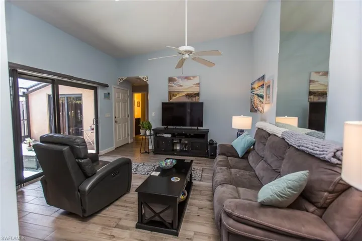 Living room featuring tile floors and a ceiling fan