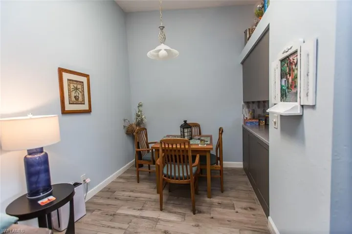 Dining room with light wood-style tiles & skylight