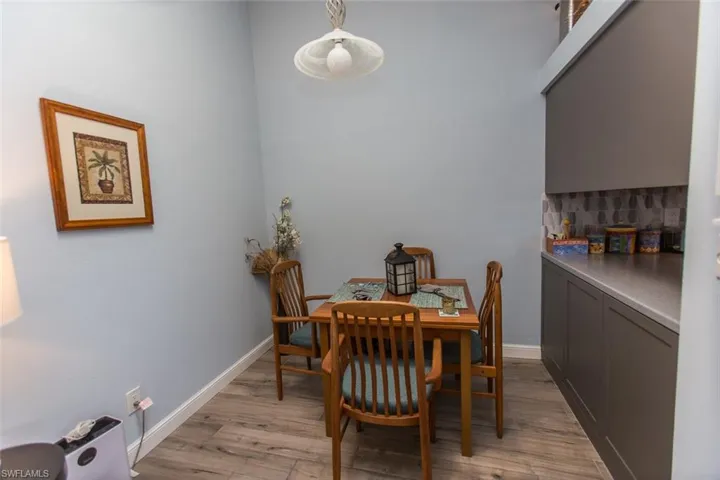 Dining room featuring light wood-style tiles and baseboards