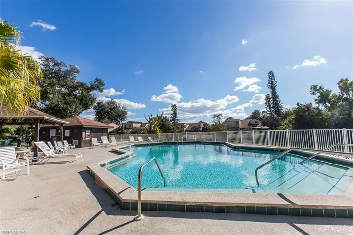 Community pool with a patio area and a gazebo