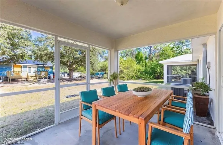Sunroom with outdoor dining space and a patio area