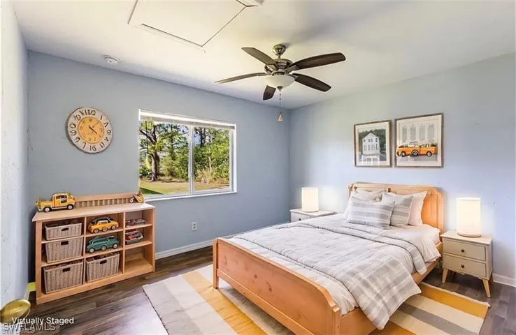 Bedroom featuring wood finished floors and a ceiling fan