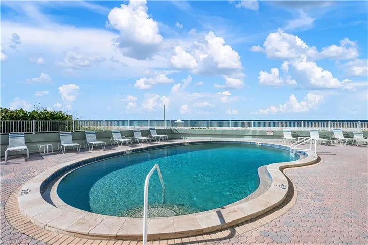 Community pool with a patio