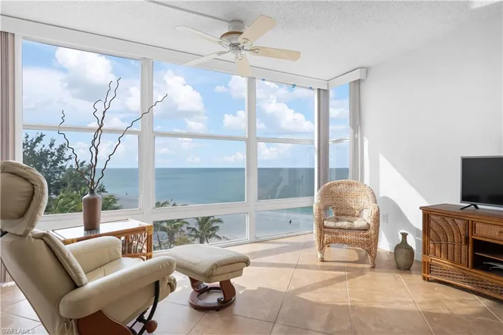 Sunroom / solarium featuring floor to ceiling windows, plenty of natural light, tile patterned flooring, and a textured ceiling