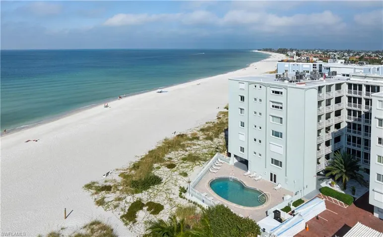Aerial view of unending shoreline and a pool