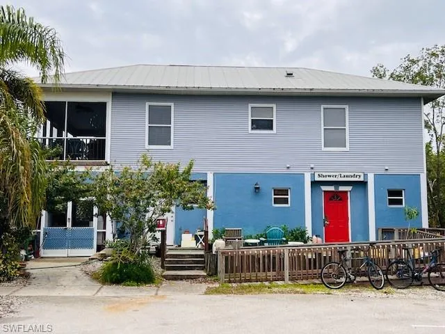 View of front of home with a metal roof and a sunroom