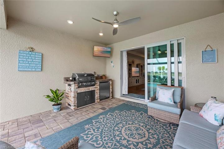 New outdoor kitchen with grill, refrigerator and mounted TV (June 2023), and new ceiling fan/light (October 2022)