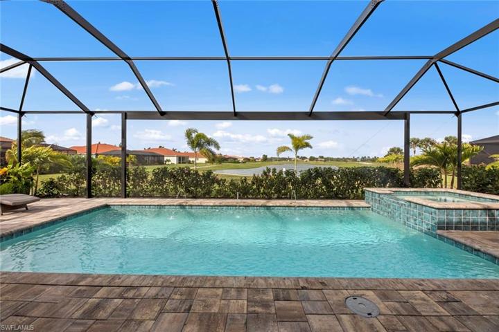 New extended screened cage with PICTURE FRAME screen, long lake and golf course views, HEATED POOL and SPA with pool lights, deck jets, and waterfall feature (March 2023). New landscaping and stone edging (April 2023).
