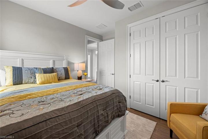 Bedroom 3 with new WOOD-LOOK TILE FLOOR (October 2022), new ceiling fan/ight (October 2022), and window blinds.