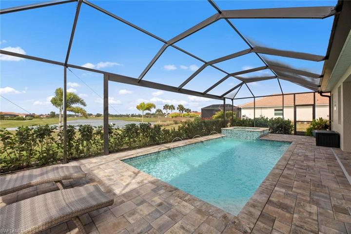 New extended screened cage with PICTURE FRAME screen, long lake and golf course views, HEATED POOL and SPA with pool lights, deck jets, and waterfall feature (March 2023). New landscaping and stone edging (April 2023).New hose bib on lanai (June 2023).
