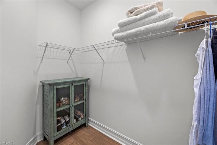 Primary bedroom has 2 WALK-IN CLOSETS with new WOOD-LOOK TILE (October 2022).