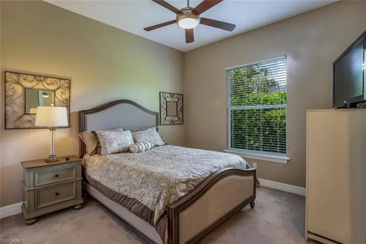 Carpeted bedroom with ceiling fan