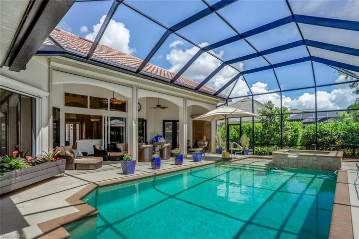 View of pool featuring outdoor lounge area, ceiling fan, a lanai, an in-ground spa, and patio area