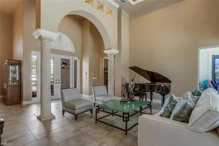 Great room with a coffer lighted ceiling and ornate columns