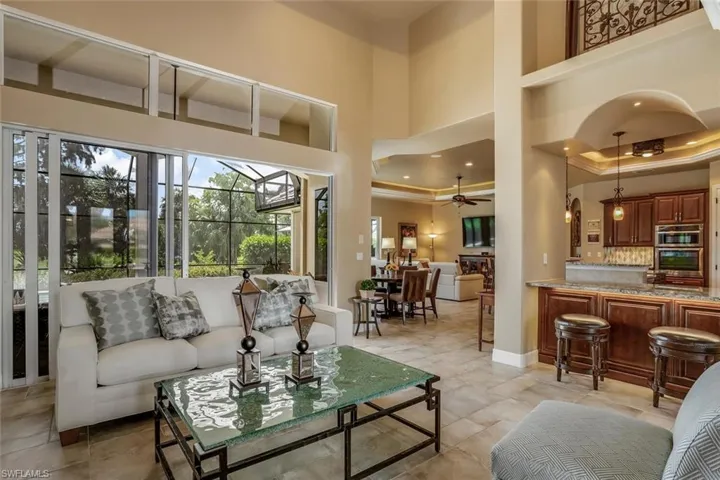 Great room featuring recessed lighting, crown molding, and a high ceiling