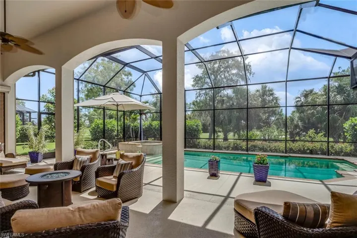 View of salt-water pool, lanai, fire pit & furniture, ceiling fan, in-ground spa & spectacular view