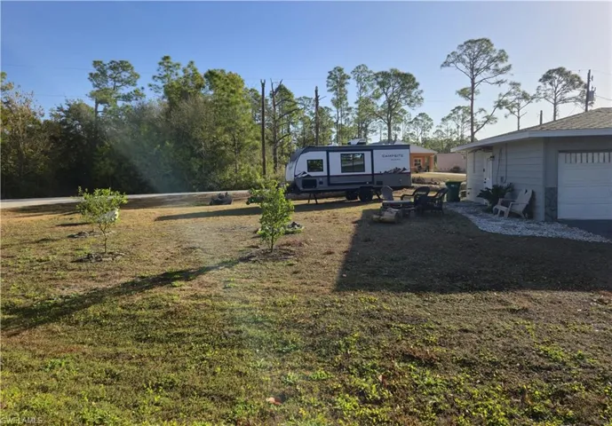 View of front facade featuring a front lawn and a garage