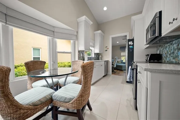 Kitchen featuring stainless steel appliances, tasteful backsplash, white cabinetry, and recessed lighting