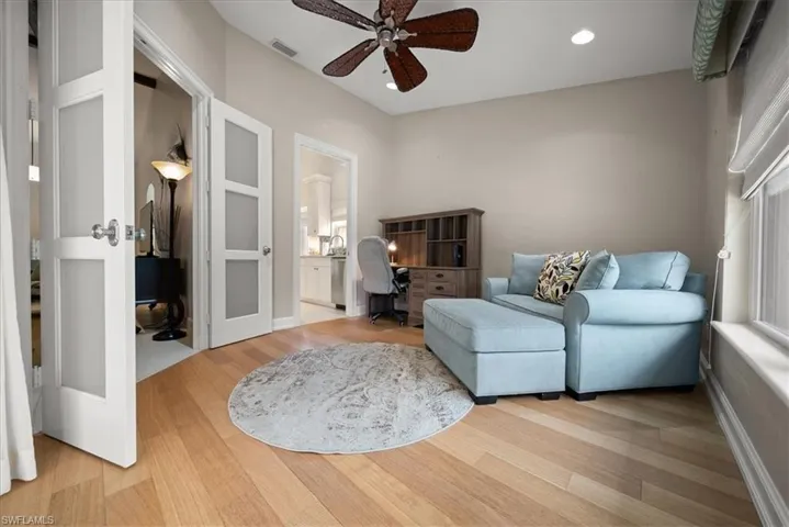 Sitting room with a ceiling fan, wood finished floors, an office area, recessed lighting, and french doors