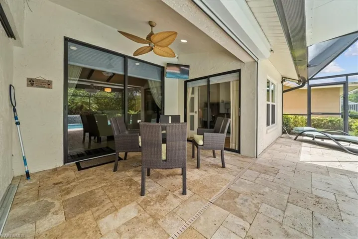 View of patio / terrace with a lanai, ceiling fan, and outdoor dining space