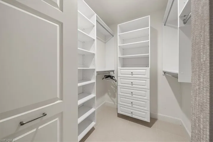 Walk in closet featuring tile patterned flooring