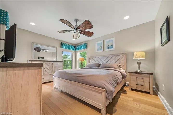 Bedroom with light wood finished floors, recessed lighting, and a ceiling fan
