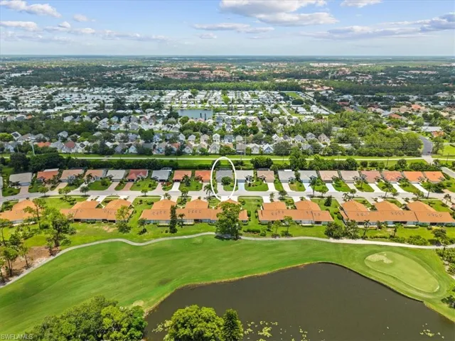 Aerial overview of property's location with a nearby body of water, nearby suburban area, and a local golf course