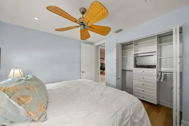 Bedroom featuring dark wood finished floors, a closet, a ceiling fan, and recessed lighting