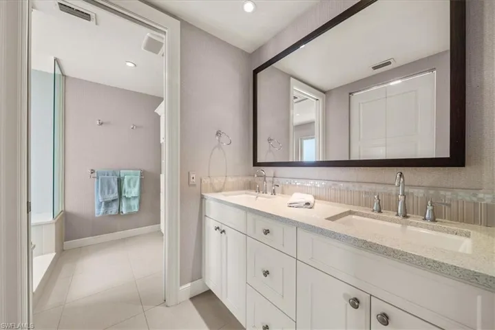 Full bathroom with double vanity and tile patterned floors