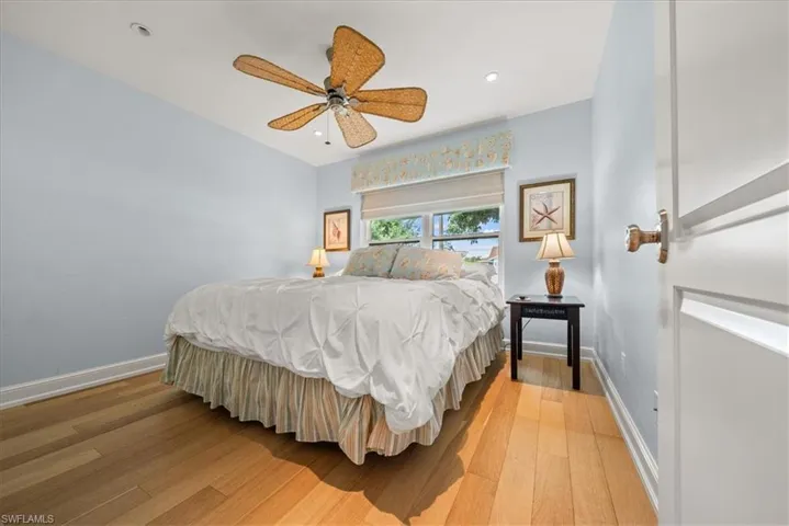 Bedroom with light wood-style floors, recessed lighting, and ceiling fan